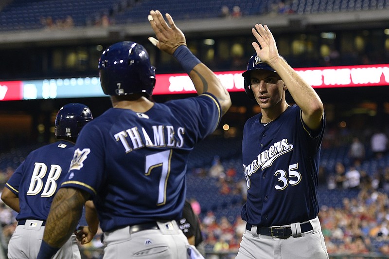 
              Milwaukee Brewers' Brent Suter, right, high-fives Eric Thames (7) after scoring on a Ryan Braun double during the third inning of a baseball game against the Philadelphia Phillies, Saturday, July 22, 2017, in Philadelphia. (AP Photo/Derik Hamilton)
            