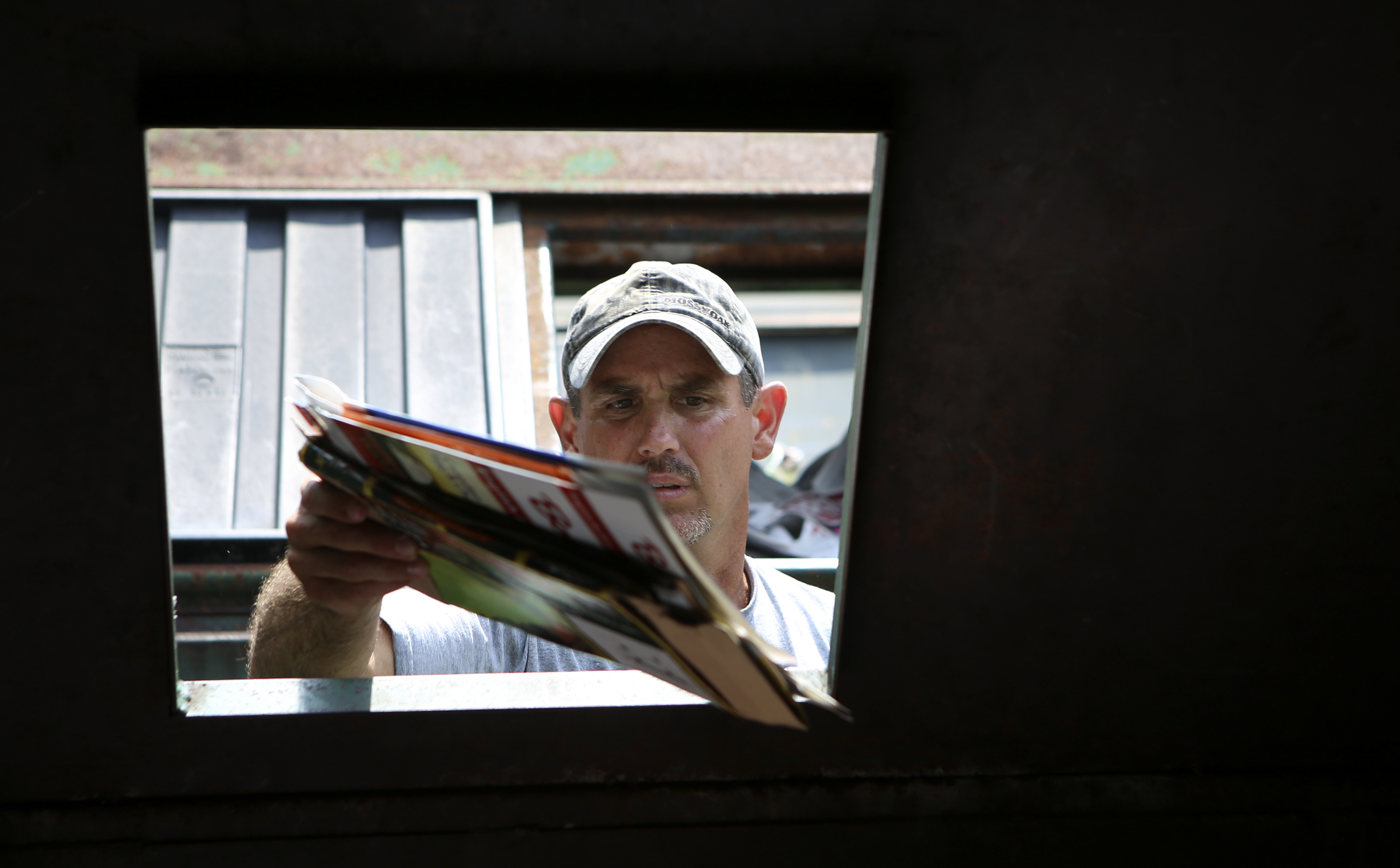 Ben Duvall, of Sale Creek, tosses away some items to be recycled at the Sequoyah Recycling Center on Thursday, July 20, in Soddy-Daisy, Tenn. The Sequoyah Transfer Station located next to the county-run recycling center is closing permanently, however, the recycling center will stay open.