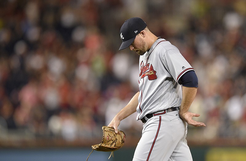 Atlanta Braves relief pitcher Jim Johnson walks to the dugout after he was pulled from a baseball game during the ninth inning against the Washington Nationals, Friday, July 7, 2017, in Washington. (AP Photo/Nick Wass)