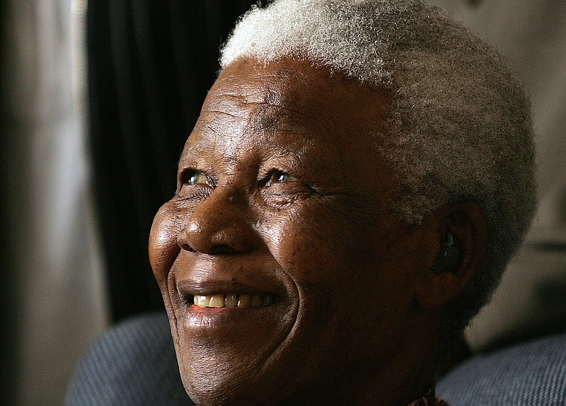 
              FILE -- In this Jan. 31, 2006 file photo former South African President Nelson Mandela smiles during his meeting in Johannesburg, South Africa. Some relatives of Mandela say a new book by a military doctor that documents Mandela's treatment before his 2013 death violates doctor-patient confidentiality. However, the now-retired doctor, Vejay Ramlakan, said in an interview broadcast over the weekend on the eNCA news channel that the Mandela family had requested that the book be written. (AP Photo/Themba Hadebe, File)
            