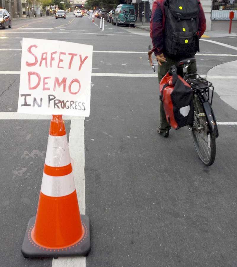 
              In this photo provided by the San Francisco Transformation Department, an orange cone separates cyclists from traffic on a San Francisco street on Monday, October 24, 2016. The divider was the work of the San Francisco Transformation Department, one of several like-minded groups of anonymous Twitter users who have taken a do-it-yourself approach to making road improvements in cities stretching from New York and Boston to Dallas.  (Twitter via AP)
            