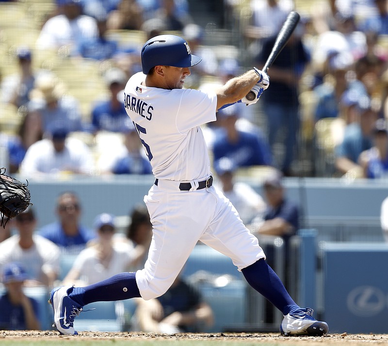 
              Los Angeles Dodgers' Austin Barnes watches his three-run home run against the Atlanta Braves during the fourth inning of a baseball game in Los Angeles, Sunday, July 23, 2017. (AP Photo/Alex Gallardo)
            