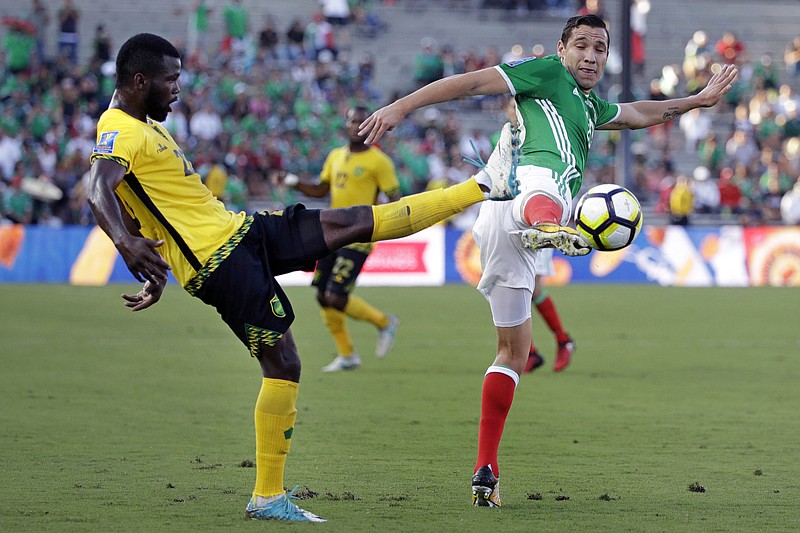 
              Jamaica's Kemar Lawrence, left, and Mexico's Jesus Duenas battle for the ball during the first half of a CONCACAF Gold Cup semifinal soccer match in Pasadena, Calif., Sunday, July 23, 2017. (AP Photo/Jae Hong)
            