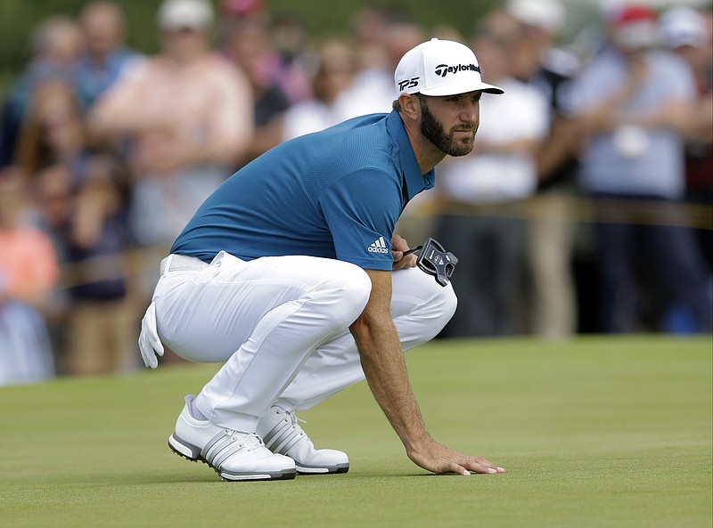 
              Dustin Johnson of the United States lines up a putt on the 14th green during the third round of the British Open Golf Championship, at Royal Birkdale, Southport, England, Saturday July 22, 2017. (AP Photo/Alastair Grant)
            