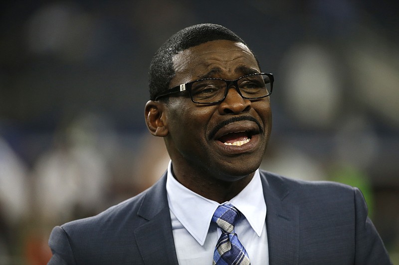 
              FILE - In this Sept. 1, 2016, file photo, broadcast personality and former Dallas Cowboys player Michael Irvin talks with people on the field before a preseason NFL football game between the Cowboys and Houston Texans, in Arlington, Texas. Prosecutors say there's insufficient evidence to file sexual assault charges against Michael Irvin, a former football star for the Dallas Cowboys and the University of Miami. A 27-year-old woman accused Irvin of drugging and sexually assaulting her at the W Hotel in Fort Lauderdale in March. (AP Photo/Ron Jenkins, File)
            