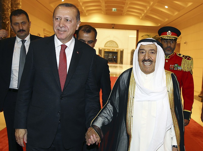 
              Turkey's President Recep Tayyip Erdogan, left, walks with Emir of Kuwait Sheikh Sabah Al Ahmad Al Sabah, right, prior to their meeting in Kuwait City, Kuwait, Sunday, July, 23, 2017. Erdogan is in a two day tour in the Middle East, that already took him to Saudi Arabia, Kuwait and will also visit Qatar. (Presidency Press Service/Pool Photo via AP)
            