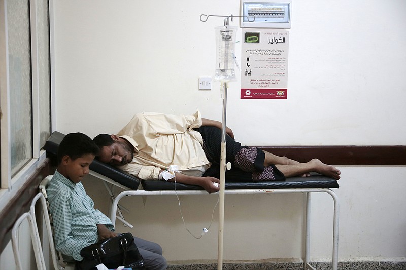 
              FILE - In this Saturday, July 1, 2017, file photo, a man is treated for suspected cholera infection at a hospital in Sanaa, Yemen. Since April, a cholera epidemic has ravaged the country with around 400,000 suspected cases and over 1,800 deaths. The rainy season underway threatens to worsen the situation and the number of cholera cases is expected to double by the end of the year, according to ICRC. (AP Photo/Hani Mohammed, File)
            