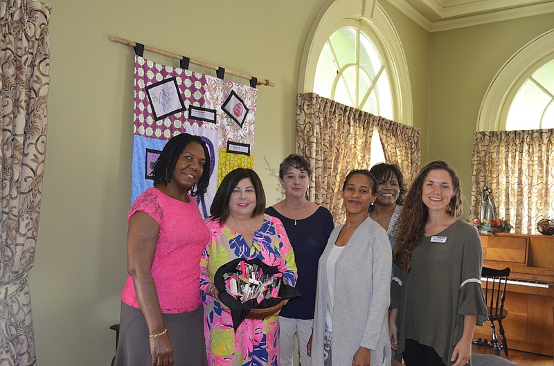 From left, friends Kuntima Nemafuta, Janet Sivils and Janice Meissner present lipsticks to Partnership officials Constance Dawes-Shazier, Dr. Sabrina Sammons and Racie Hoffman. (Contributed photo)