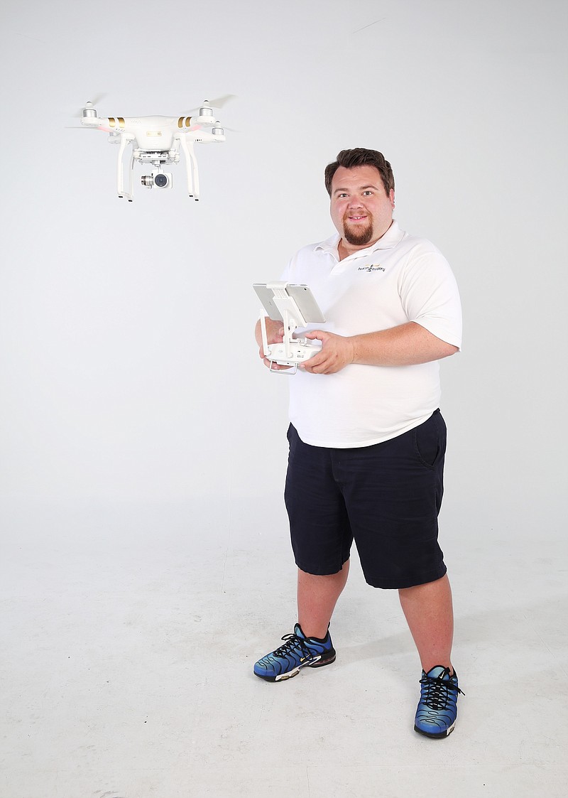 Nic Powell of Beacon Imagery demonstrates a drone he uses to take real estate photos for a variety of agencies.