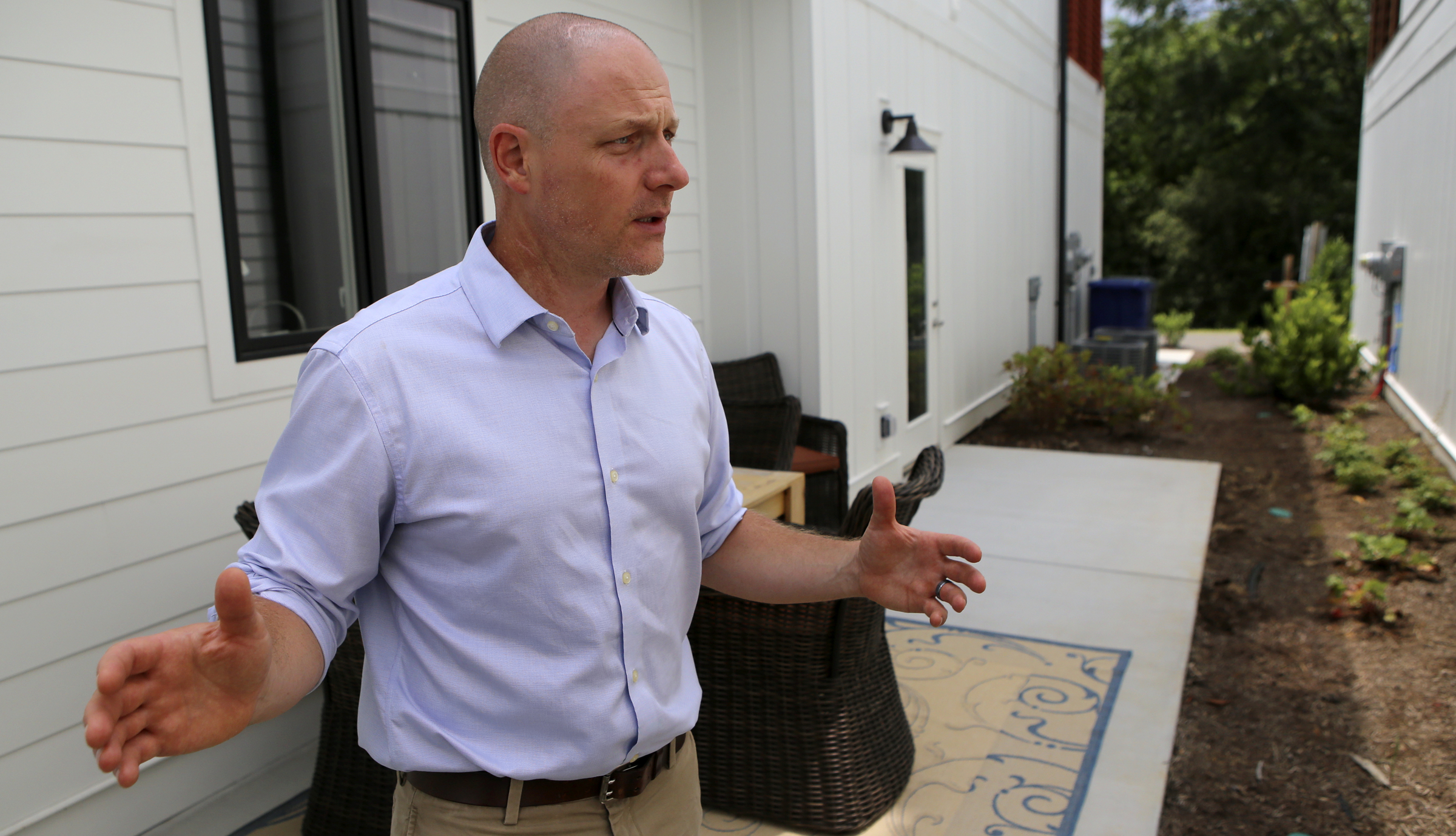 Ethan Collier gives a tour of the private space between homes of the new development One Hundred at South Broad on Wednesday, July 12, in Chattanooga, Tenn.