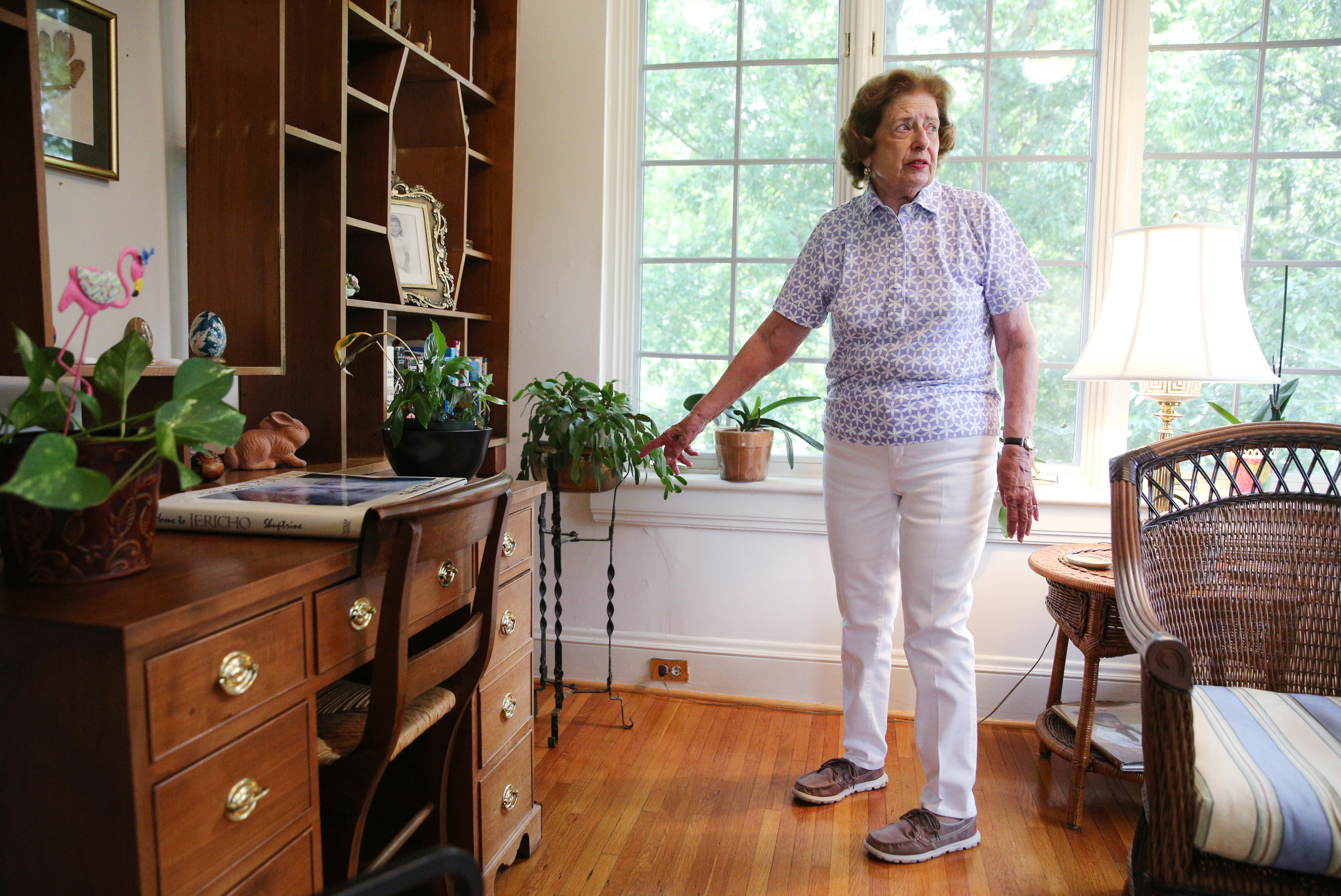 Barbara Blake points to a few of the original electrical outlets behind her bookshelf, such as a cigar lighter, that are no longer in use Wednesday, July 12, 2017, at her home on Sunset Road in Chattanooga, Tenn. The house was known as Chattanooga's Model Electric Home.