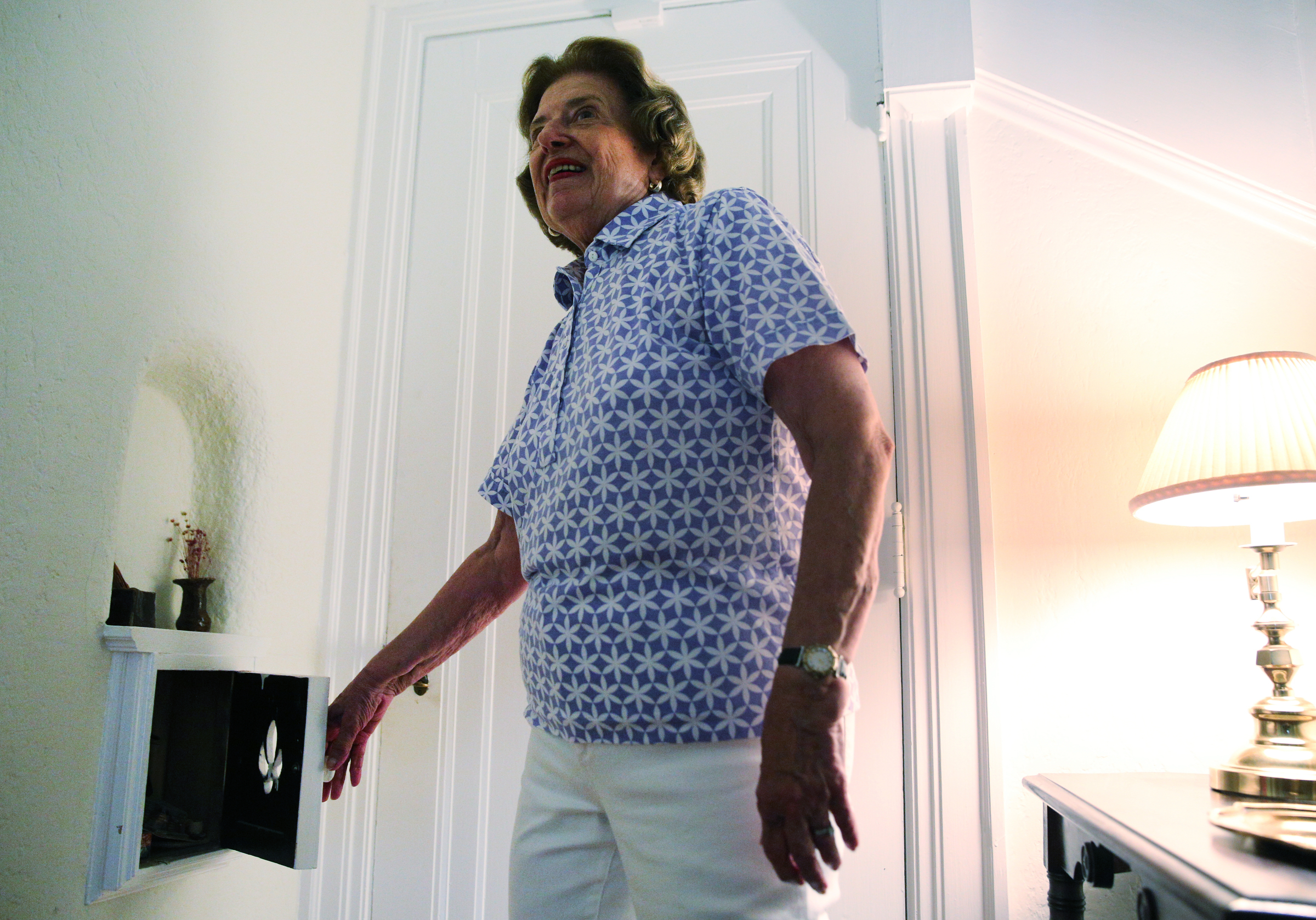 Barbara Blake opens up a box below where the old phone used to sit Wednesday, July 12, 2017, at her home on Sunset Road in Chattanooga, Tenn. The house was built in 1925.