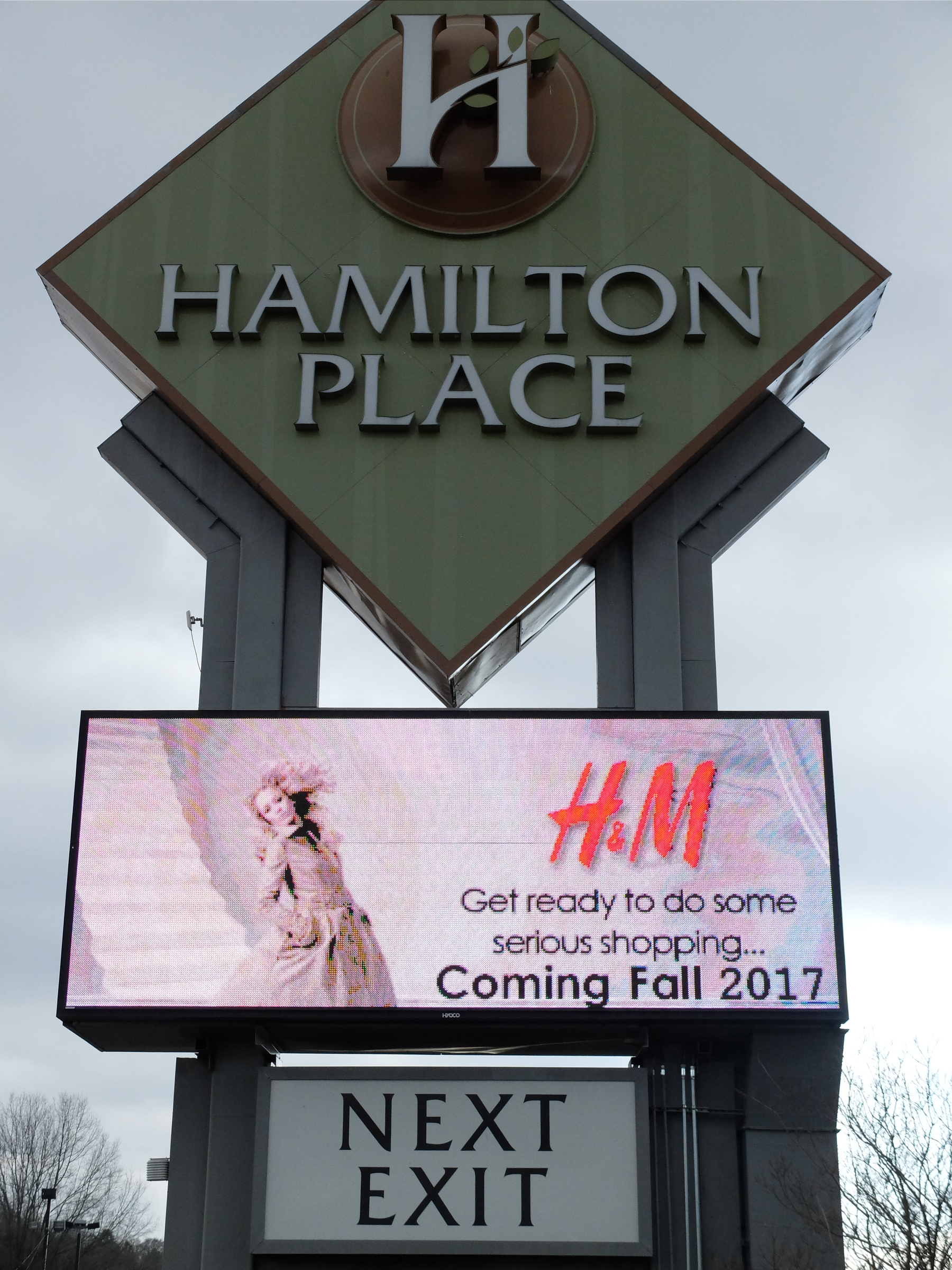 The Hamilton Place Mall sign facing Interstate 75 announces the H&M store arrival later this year.