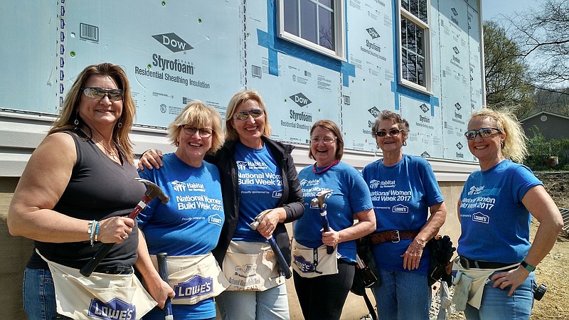 Real estate agents Debra Sanders, Sandy Hardin, Jelena Butler, Angie Pickett, Diane Barnes, and Belvely Davis outside the house they helped construct on Taylor Street.