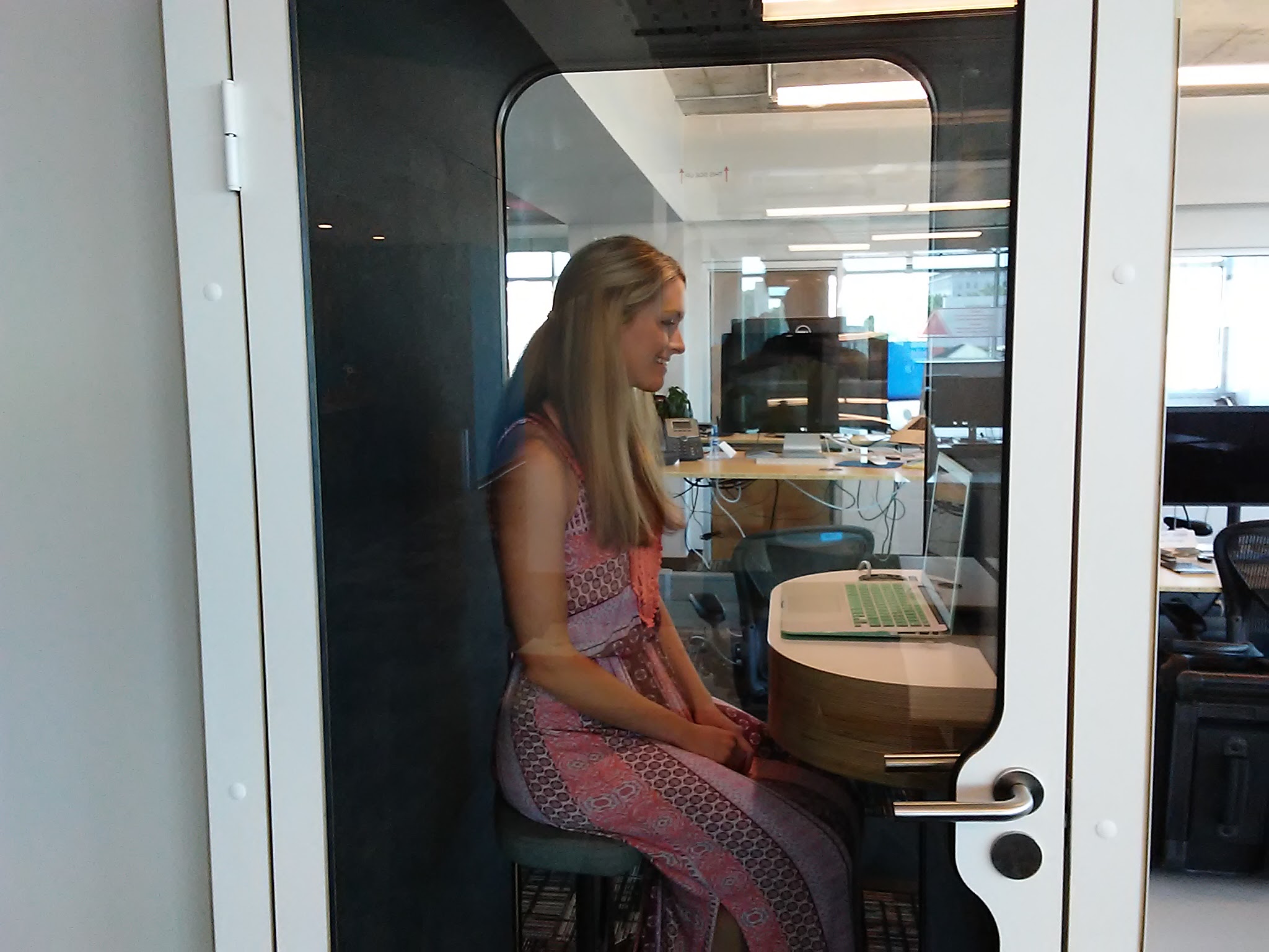 Skuid copywriter Veronica Goudzward sits inside one of a dozen Finnish phone booths that the Chattanooga software company has scattered around its three floors in Liberty Tower downtown.