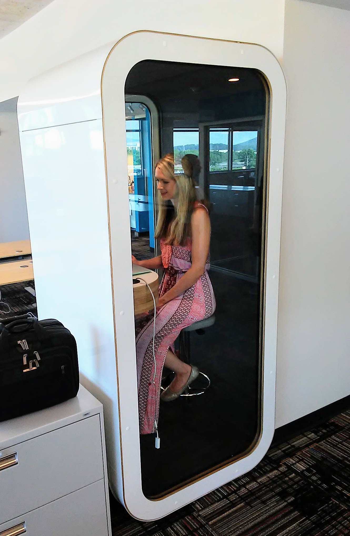 Skuid copywriter Veronica Goudzward sits inside one of a dozen Finnish phone booths that the Chattanooga software company has scattered around its three floors in Liberty Tower downtown.