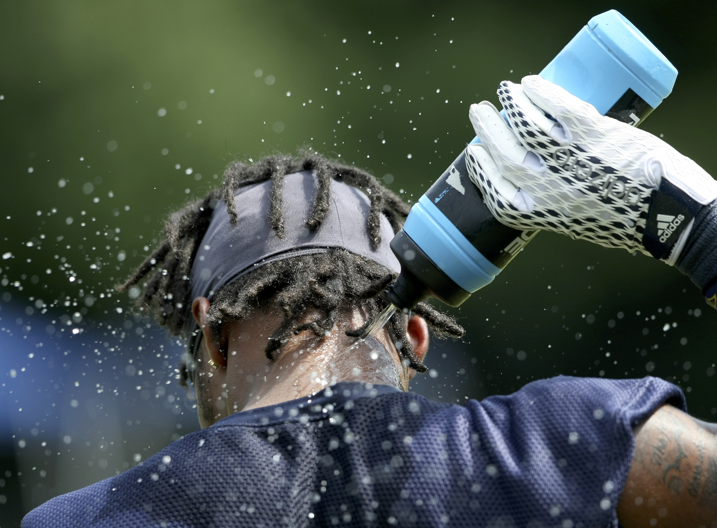 UTC defensive back Cameron Turner sprays water on the back of his neck during the first day of fall practice at Scrappy Moore Field on Monday, July 24, in Chattanooga, Tenn.