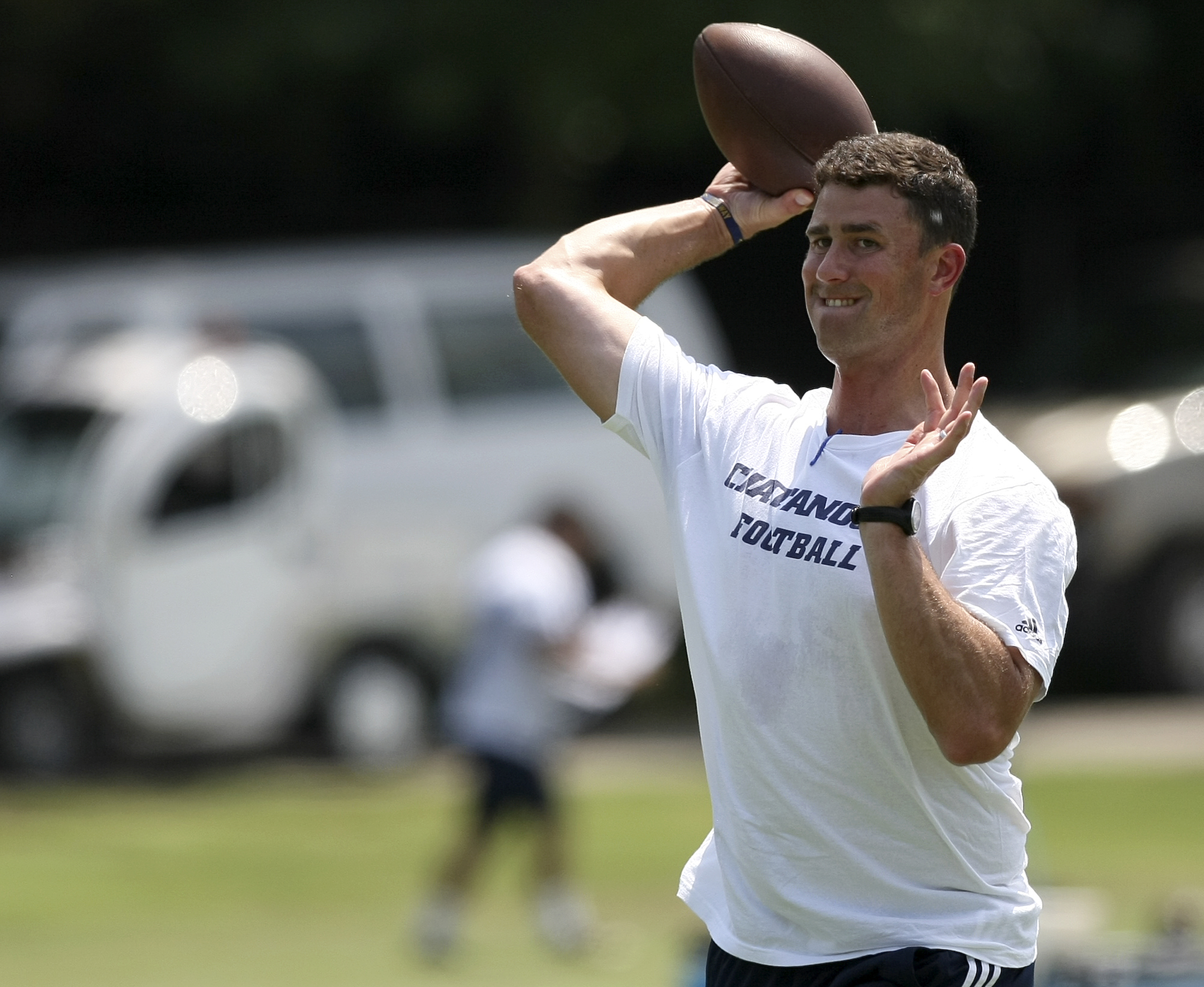 UTC head coach Tom Arth throws a ball during the first day of fall practice at Scrappy Moore Field on Monday, July 24, in Chattanooga, Tenn.