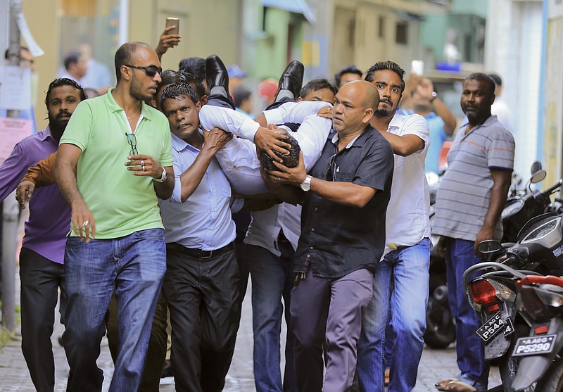 
              Maldivian lawmaker Faisal Naseem who was injured in clashes with police is rushed to a hospital in Male, Maldives, Monday, July 24, 2017. The Maldivian opposition says the military has locked down parliament on the orders of the country's president in a bid to prevent lawmakers from taking part in a vote to impeach the parliamentary speaker. (AP Photo/Ahmed Shurau)
            