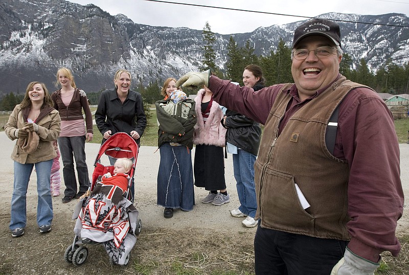 
              FILE - In this April 21, 2008, file photo, Winston Blackmore, the religious leader of the controversial polygamous community of Bountiful located near Creston, British Columbia, Canada, shares a laugh with six of his daughters and some of his grandchildren. Blackmore has been convicted of practicing polygamy after a decades-long legal fight. Blackmore was found guilty Monday, July 24, 2017, by British Columbia Supreme Court Justice Sheri Ann Donegan. (Jonathan Hayward/The Canadian Press, via AP, File)
            