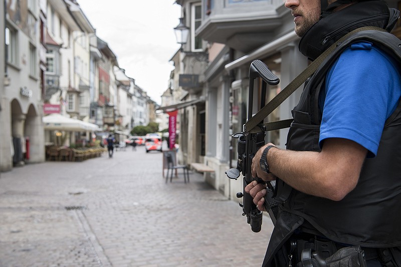 
              The police shut down the old town of Schaffhausen in Switzerland, while they search for an unknown man who attacked people, on Monday, July 24, 2017. Swiss police say five people have been hospitalized, two of them with serious injuries, following the apparent attack in the northern city of Schaffhausen. (Ennio Leanza/Keystone via AP)
            