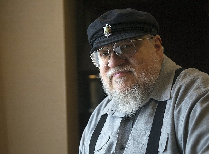 
              FILE - In this March 12, 2012 file photo, George R.R. Martin, author of the popular book series "A Song of Ice and Fire," which inspired the hit HBO series "Game of Thrones" poses in Toronto. Martin says the next “Song of Ice and Fire” book has a real chance of coming out in 2018. In a weekend posting on his web site, Martin wrote that he is working hard on “The Winds of Winter,” the long-awaited sixth volume in the series. He added that he has “good days and bad days” and is still months away from finishing.    (AP Photo/The Canadian Press, Nathan Denette, File)
            