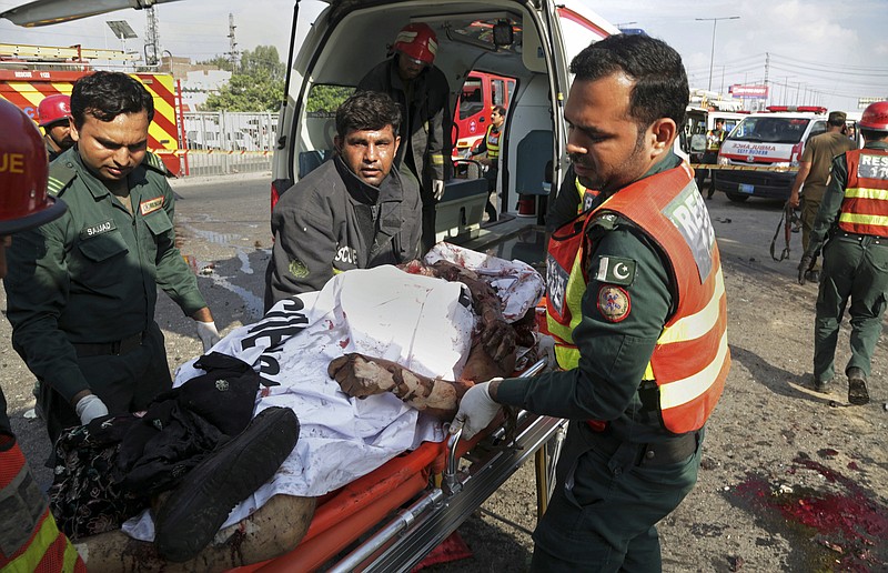 
              Pakistani rescue workers remove a body from the site of a deadly bombing in the eastern city of Lahore, Pakistan, Monday, July 24, 2017. Pakistani officials said that the suicide motorcycle bombing killed over 20 people and wounded more than 20 others at a vegetable market in the neighborhood of Kot Lakhpat on Lahore's outskirts. (AP Photo/K.M. Chaudary)
            