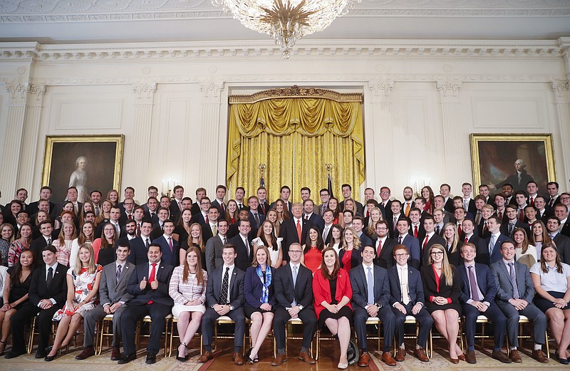 
              President Donald Trump, center, poses for a photo with outgoing White House interns in the East Room of the White House in Washington, Monday, July 24, 2017. (AP Photo/Pablo Martinez Monsivais)
            