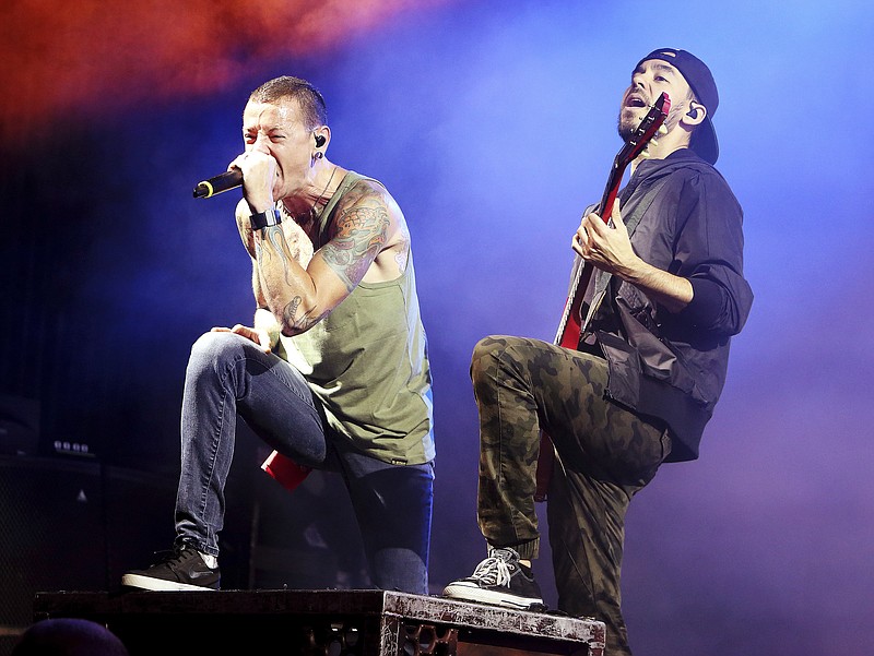 FILE - In this Aug. 15, 2014, file photo, Chester Bennington, left, and Mike Shinoda of the band Linkin Park perform in concert during their "Carnivores Tour 2014" at the Susquehanna Bank Center in Camden, N.J. Billboard said July 23, 2017, that the band's albums have returned to its album charts following Bennington's July 21 death. (Photo by Owen Sweeney/Invision/AP, File)