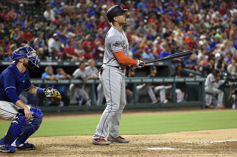 
              Miami Marlins right fielder Giancarlo Stanton (27) and Texas Rangers catcher Jonathan Lucroy (25) watch the flight of Stanton's second home run of the game during the eighth inning of a baseball game, Monday, July 24, 2017, in Arlington, Texas. (AP Photo/Jeffrey McWhorter)
            