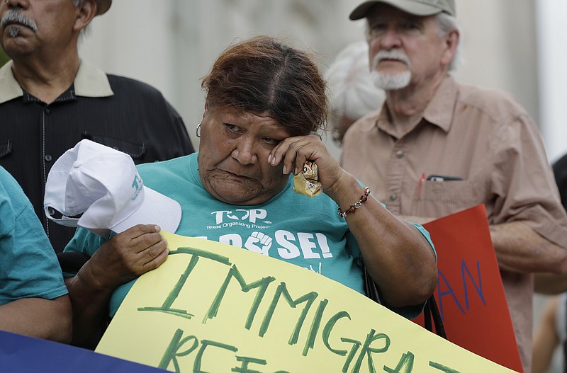 
              Eldia Contreras wipes away a tear as she takes part in a vigil at San Fernando Cathedral for victims who died as a result of being transported in a tractor-trailer Sunday, July 23, 2017, in San Antonio. Several people died after being crammed into a sweltering tractor-trailer found parked outside a Walmart in the midsummer Texas heat, authorities said Sunday in what they described as an immigrant-smuggling attempt gone wrong. (AP Photo/Eric Gay)
            