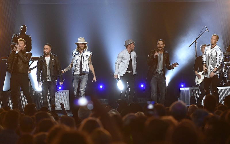 
              FILE - In this April 2, 2017 file photo, Tyler Hubbard, from right, and Brian Kelley, third from left, of Florida Georgia Line, and from left, Nick Carter, AJ McLean, Brian Littrell, and Kevin Richardson, of Backstreet Boys, perform at the 52nd annual Academy of Country Music Awards in Las Vegas. Backstreet Boys got their first hit country song this year on a collaboration with country duo Florida Georgia Line and now the two powerhouse acts are teaming up for a “CMT Crossroads” episode airing Aug. 30. (Photo by Chris Pizzello/Invision/AP, File)
            