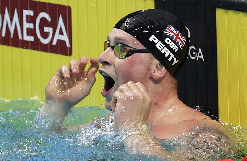 
              Britain's Adam Peaty celebrates after setting a new world record in a men's 50-meter breaststroke semifinal during the swimming competitions of the World Aquatics Championships in Budapest, Hungary, Tuesday, July 25, 2017. (AP Photo/Michael Sohn)
            