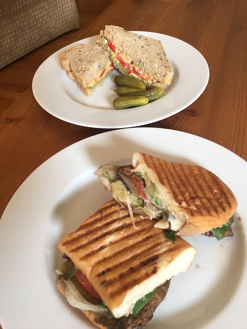 The Vegan De Light, top, and the portobello mushroom panini come with pickles and coleslaw on the side.