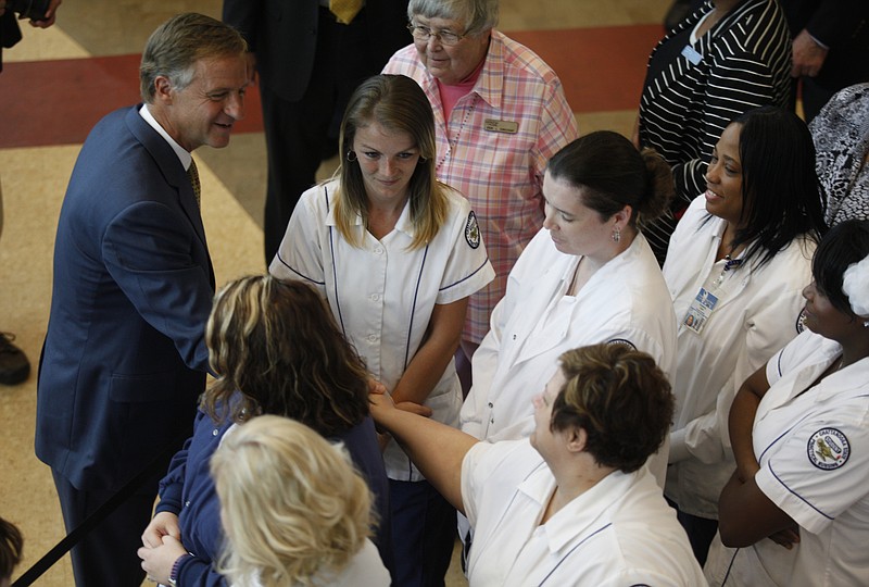 Tennessee Gov. Bill Haslam shakes hands with practical nursing students after signing into law the Tennessee Promise program at Chattanooga State Technical Community College in 2013.