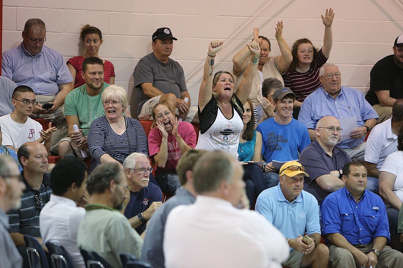 Citizens of Varnell express their joy as the city council meeting is canceled due to low attendance of council members Tuesday, July 25, 2017, at the Varnell City Gym in Varnell, Ga. The Varnell City Council were meeting to decide whether or not to eliminate its police department.