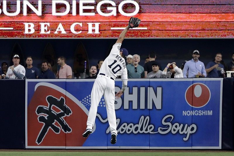 
              San Diego Padres right fielder Hunter Renfroe makes a leaping catch for an out against New York Mets' Wilmer Flores during the fifth inning of a baseball game Monday, July 24, 2017, in San Diego. (AP Photo/Gregory Bull)
            