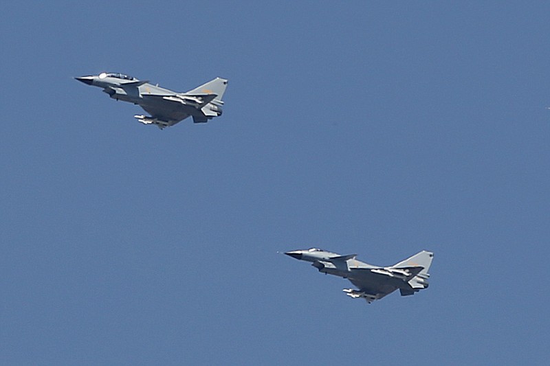 
              In this Sept. 3, 2015, file photo, two Chinese J-10 fighter jets fly in formation during a parade commemorating the 70th anniversary of Japan's surrender during World War II in Beijing. China on Tuesday, July 25, 2017, denied that two of its J-10 fighter jet pilots operated dangerously during an encounter with a U.S. surveillance plane in international airspace in which the American pilot took evasive action to avoid a possible collision. (AP Photo/Mark Schiefelbein, File)
            