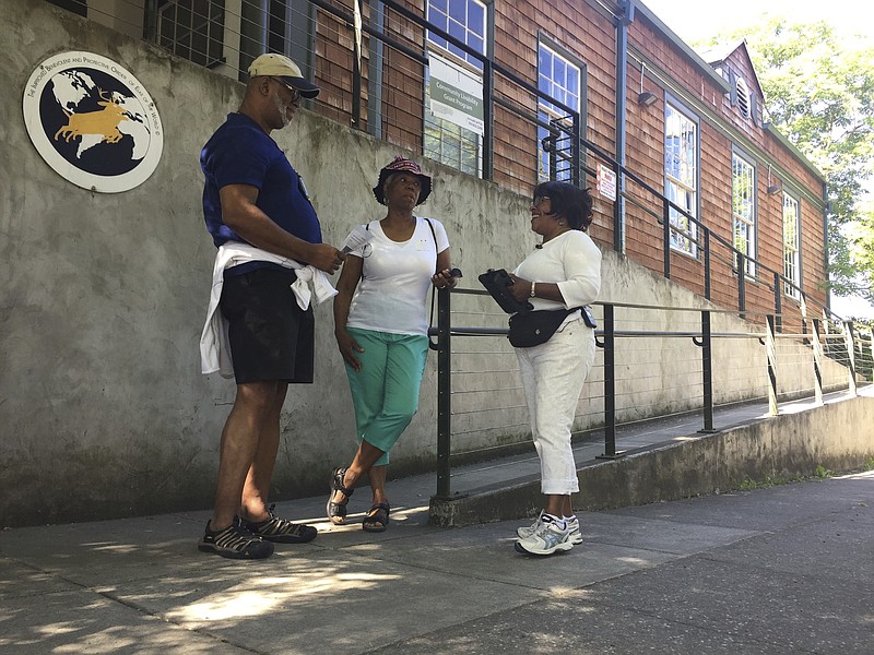 
              In this photo taken July 6, 2017, from left, Ron Young, Gahlena Easterly and Sharon Steen reminisce as they take a mile-long walk through North Portland, Ore. streets that once were full of black-owned homes and businesses. Researchers are studying whether jogging memories where they were made can help African-American seniors stay sharp and slow early memory loss. (AP Photos/Gillian Flaccus)
            