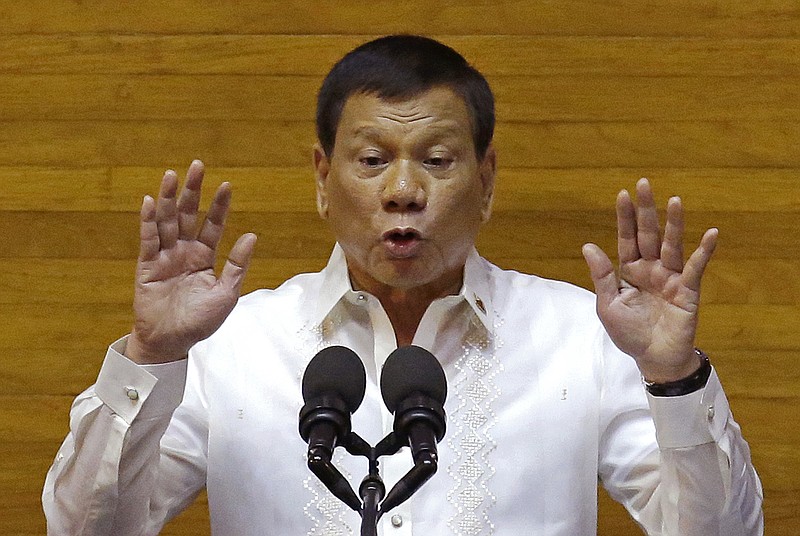 
              FILE - In this Monday, July 24, 2017, file photo, Philippine President Rodrigo Duterte gestures during his second State of the Nation Address at the House of Representatives in Quezon city, north of Manila, Philippines. (AP Photo/Aaron Favila)
            