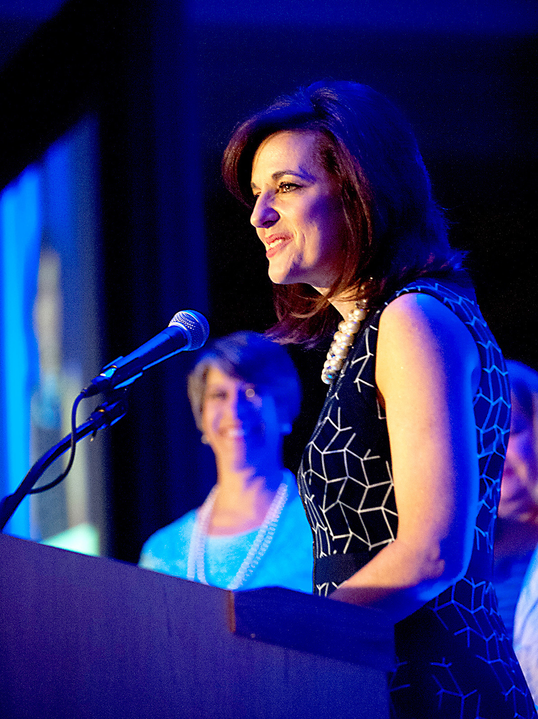 Jody Biggs (front) introduces this year's Lydia Award winner, Julie Baumgardner.