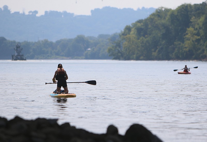 VML Art Director Mars Denton paddle boards Thursday, July 20, 2017, on the Tennessee River at the Market Street Bridge in Chattanooga, Tenn. A group of three from VML went paragliding, bouldering, slacklining, paddleboarding, kayaking, climbing and mountain biking during a visit to Chattanooga. 