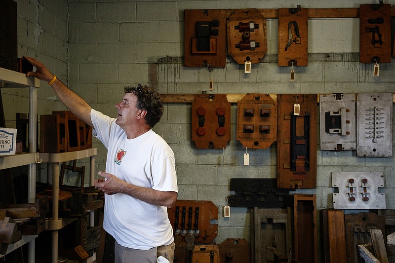 Owner Greg Ross stands in front of a wall of foundry patterns at his store, Estate of Confusion, on Main Street on Tuesday, March 21, 2017, in Chattanooga, Tenn.