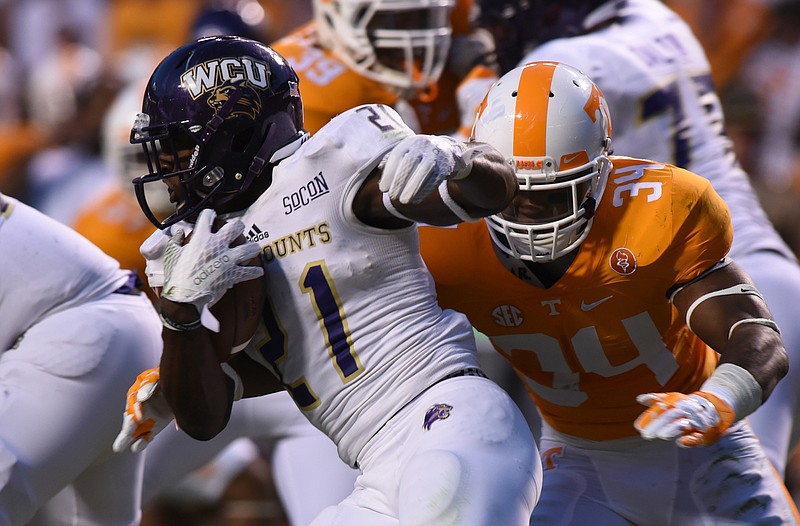 Western Carolina's Detrez Newsome tries to evade Tennessee linebacker Darrin Kirkland Jr. during a 2015 game at Neyland Stadium in Knoxville.