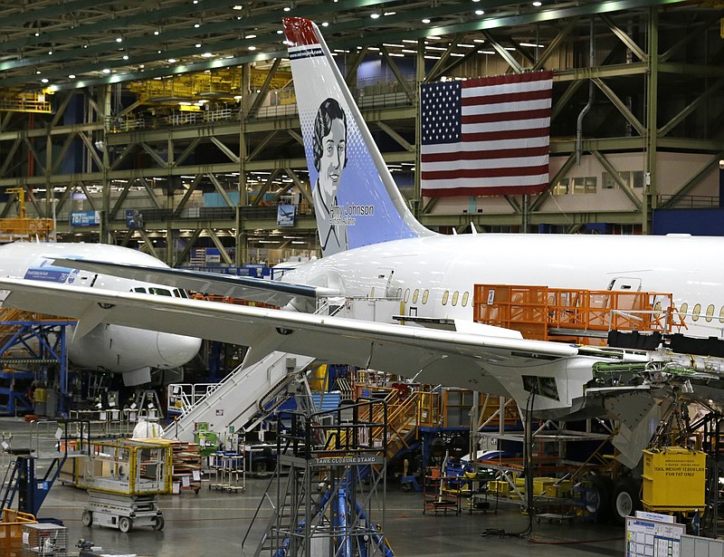 
              In this Monday, June 12, 2017, photo, a U.S. flag is displayed above a Boeing 787 airplane being built for Norwegian Air Shuttle at Boeing Co.'s assembly facility, in Everett, Wash. The Boeing Co. reports earnings, Wednesday, July 26, 2017. (AP Photo/Ted S. Warren)
            