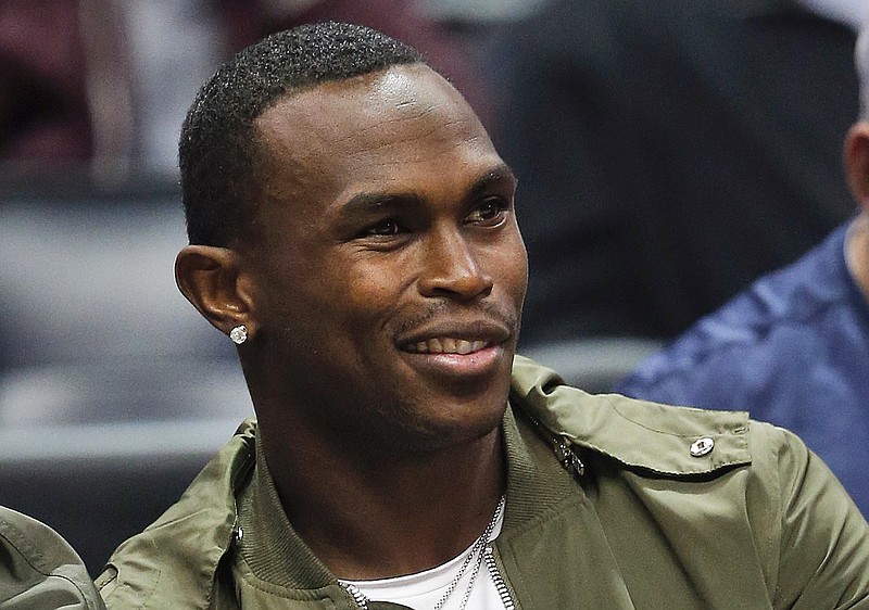 
              FILE - In this Dec. 5, 2016, file photo, Atlanta Falcons wide receiver Julio Jones watches an NBA basketball game between Atlanta Hawks and Oklahoma City Thunder in Atlanta. The star’s diamond earring valued at more than $100,000 is now presumed lost on the murky bottom of a Georgia lake. WXIA-TV reported Tuesday, july 25, 2017,  thato Jones lost it when he hit a boat wake and took a spill while jet skiing in Lake Lanier, about 50 miles outside Atlanta. (AP Photo/John Bazemore, File)
            