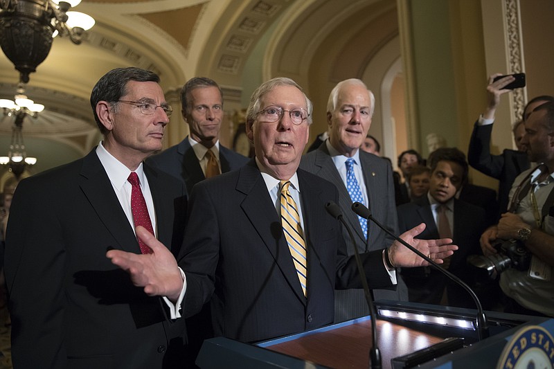 
              Senate Majority Leader Mitch McConnell of Ky., joined by, from left, Sen. John Barrasso, R-Wyo., Sen. John Thune, R-S.D., and Majority Whip John Cornyn, R-Texas, speak with reporters on Capitol Hill in Washington, Tuesday, July 25, 2017, after Vice President Mike Pence broke a 50-50 tie to start debating Republican legislation to tear down much of the Obama health care law. (AP Photo/J. Scott Applewhite)
            