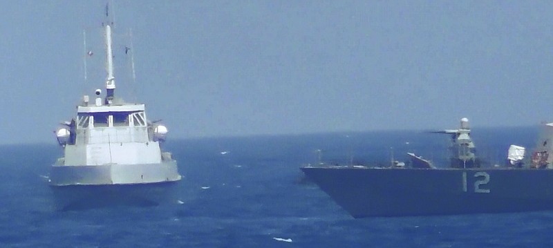 
              This handout image provided Tuesday, July 25, 2017, from the U.S. Navy purports to show an Iranian vessel making a close approach to a U.S. coastal patrol ship USS Thunderbolt, right. The U.S. Navy patrol boat fired warning shots near the Iranian vessel that American sailors said came dangerously close to them during a tense encounter in the Persian Gulf. Iran's Revolutionary Guard later blamed the American ship for provoking the situation. (U.S. Navy via AP)
            