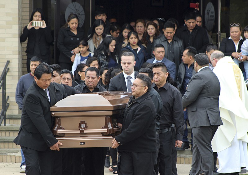 
              FILE - In this April 19, 2017 file photo, the casket of Justin Llivicura, 16, is carried from St. Joseph the Worker Church after Llivicura's funeral in East Patchogue, N.Y. Llivicura was one of four young men found slain in a suspected MS-13 gang killing in a park in Central Islip, N.Y., on April 12. President Donald Trump is scheduled travel to New York on Friday, July 28, to meet with law enforcement on Long Island and discuss the MS-13 street gang. His administration has made MS-13 a symbol of the need for stricter immigration laws. (AP Photo/Frank Eltman, File)
            