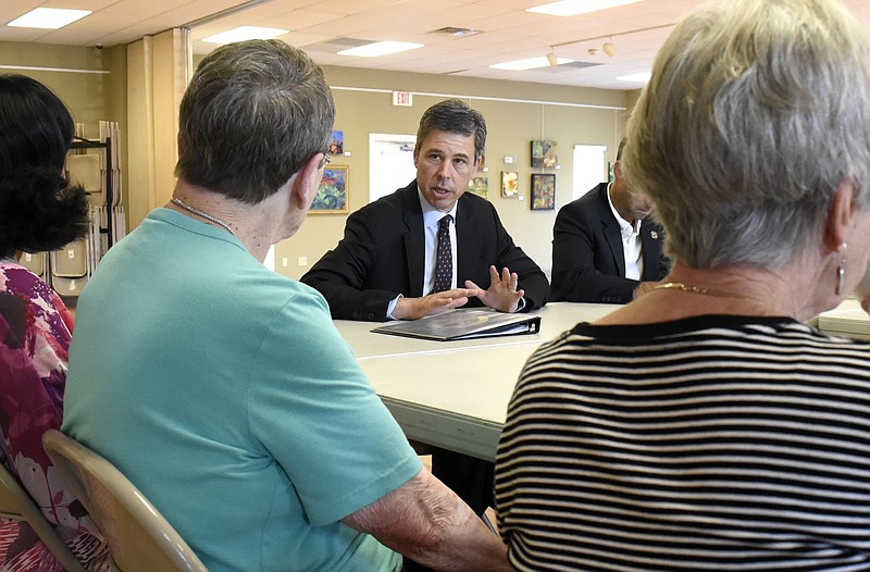 Staff Photo by Robin Rudd - Chattanooga Mayor Andy Berke and council member Ken Smith answer questions from Kitty Hilliard and other citizens concerning the effect of property taxes on seniors at the North River Civic Center on Wednesday.